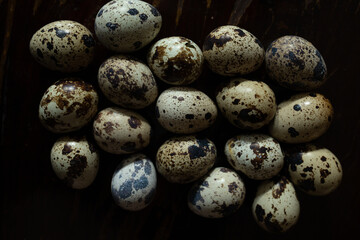 Fototapeta premium Quail eggs with one broken showing shell texture