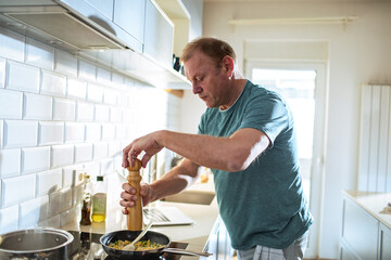 Man preparing meal in the home kitchen