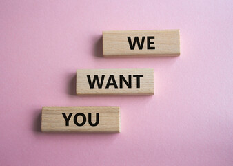 We want you symbol. Concept words We want you on wooden blocks. Beautiful pink background. Business and We want you concept. Copy space.