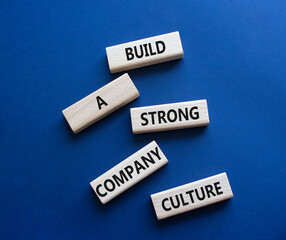 Company culture symbol. Wooden blocks with words Build a strong company culture. Beautiful deep...