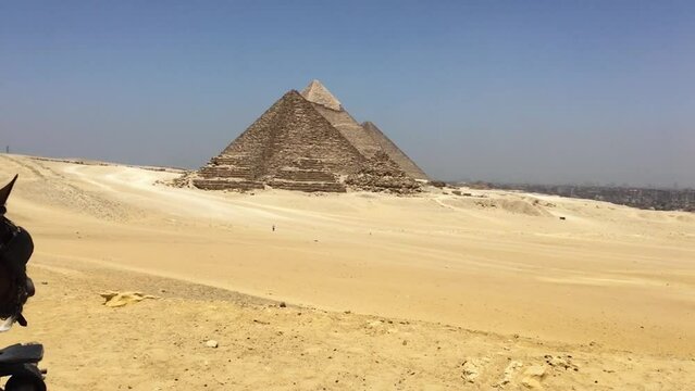 The Giza Necropolis from the desert on a horse drawn carriage.