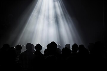 Concert atmosphere with audience silhouetted against a bright light