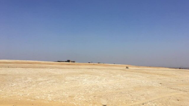 Pan across the desert to the Giza Necropolis