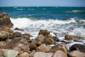 Fototapeta na wymiar The waves are crashing on the rocks. The sea is agitated once. Raging sea and rocks