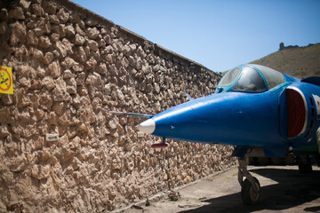 The nose of the plane. The exhibit is in the museum. A blue military aircraft. Open-air Museum