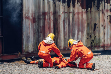 First aid support accident at work. Firefighter to save girl in fire and smoke. Rescue Team or...