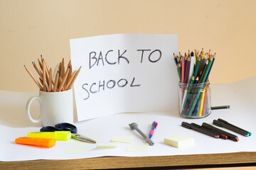 School accessories and a white paper with Back to school text written on it. School supplies, back...
