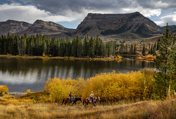 Cowboy cowgirl couple trail riding colorado wilderness autumn fall mountain  lake