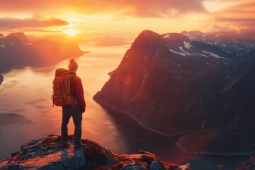 Fototapeta premium A person with a backpack standing on a mountain. Suitable for outdoor and adventure concepts