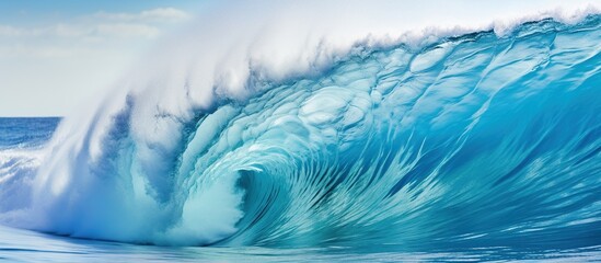 Blue ocean surfing wave during the day for travel and vacation concept background.