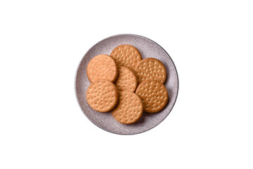 Round dotted snack snack cookies with cream on a dark concrete background