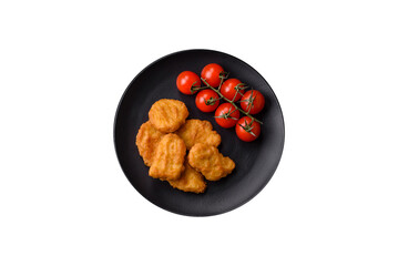Delicious fresh crispy chicken nuggets on a dark concrete background