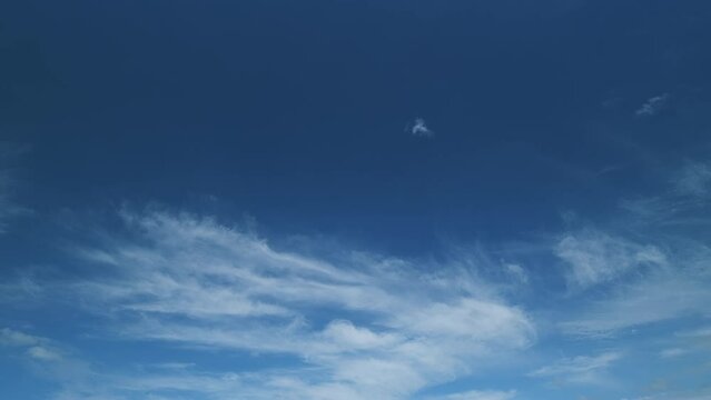 Cloud nature background. Blue sky with cirrus clouds and sun. Nature background of airy cloudscape.