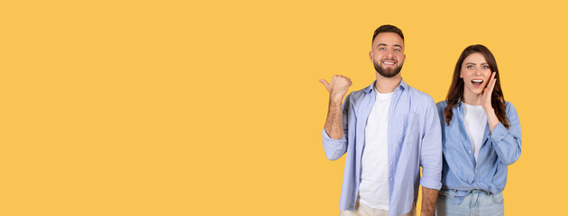 Excited couple showing blank space, woman with hand to cheek, panorama