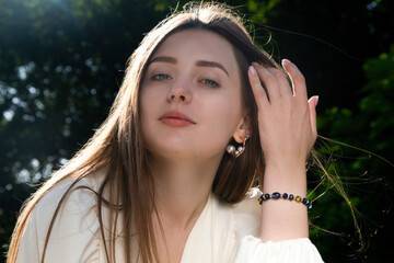 A beautiful girl straightens her hair with her hand. Happy day