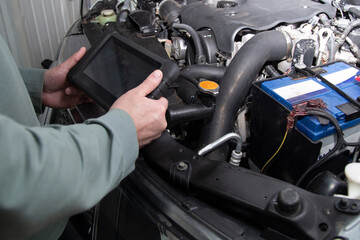Fototapeta premium Vehicle diagnostics using special equipment. Auto electrician and complete car diagnostics.