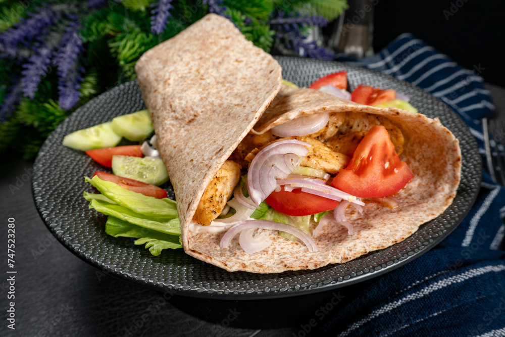 Canvas Prints wholegrain tortilla wraps with vegetables and chicken on a plate.