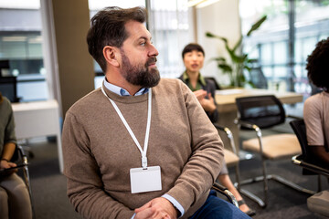 Business man listening a tutors lecture that is in his company.