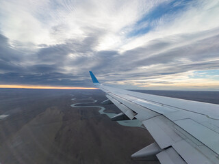Aerial View of Winding Rivers with Airplane Wing at Sunset