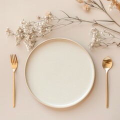 minimalist aesthetic. beige empty porcelain plate on pastel background with golden cutlery and dried flowers. 