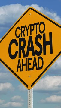 A vertical view of a hypothetical "Crypto Crash Ahead" yellow road sign over an ominous time lapse cloudy sky. Bear market concept.  	