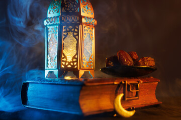 Ornamental Arabic lantern with burning candle glowing at night.Festive greeting card, invitation for Muslim holy month Ramadan Kareem.