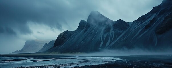 Mountains, water and black sand in Iceland.
