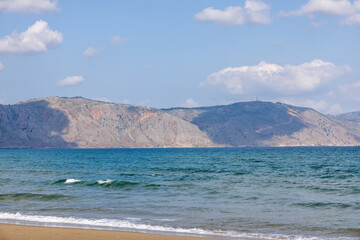 Beach with Mountains with clouds on the island of Crete in Greece in summer