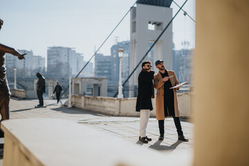Two stylish men discussing business plans outdoors in urban setting.