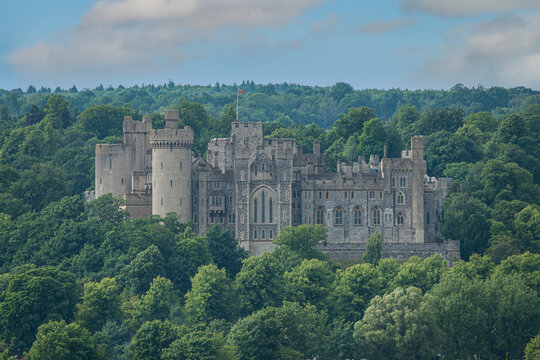 Magnificent medieval Arundel Castle surrounded with lush green forest trees