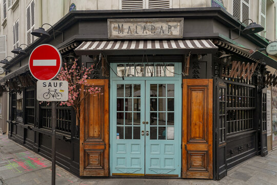 paris France 13 march 2023 : french style cafe with black painted shop facade , traditional parisian boutique