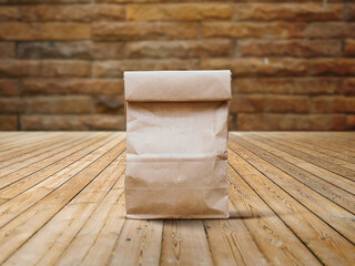 Craft paper bag isolated on wooden background