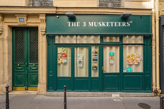 Paris France 5 may 2023 : traditional retro french fashion store facade painted in green