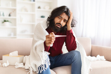 Unhappy sick indian man suffering from fever, have flu