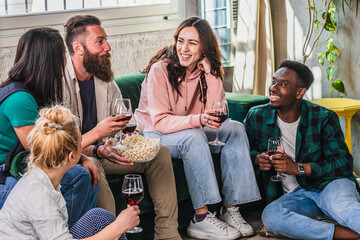 diverse group of friends enjoying wine and popcorn together