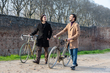 two men with bicycles enjoying a conversation on a sunny day