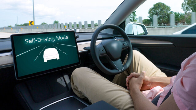 Self driving car or autonomous vehicle travel on speed highway with driverless system and autopilot mode allowing man driver relax and focus on smartphone without compromising safety. Perpetual - Powered by Adobe