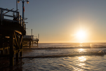 Fototapeta na wymiar Sunrise on Argentina Beach with a view of the Dock