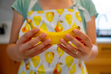 Woman hands holding bananas, natural daylight