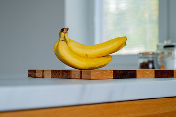 Natural sunlight graces the kitchen, highlighting a solitary banana - 747566412