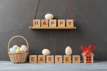 Happy Easter Spelled with Wooden Blocks and Eggs - 747566446