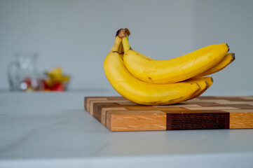 Kitchen elegance: a banana bathed in the soft glow of daylight - 747566620