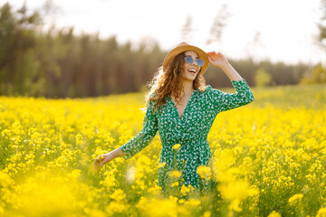 Happy woman enjoying nature on the field. Nature, vacation, relax and lifestyle. Summer landscape.