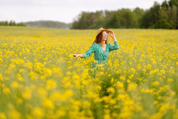 Happy woman enjoying nature on the field. Nature, vacation, relax and lifestyle. Summer landscape.