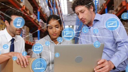 Animation of network of connections with icons over diverse workers using laptop in warehouse - Powered by Adobe