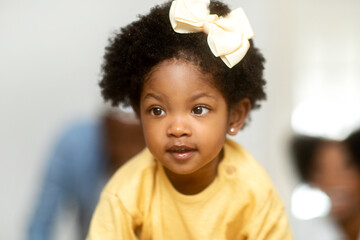 Closeup photo of adorable african american girl with hair bow