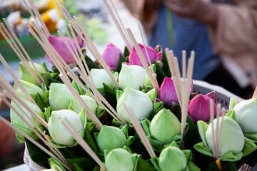 buddhist offerings on sale in front of a temple