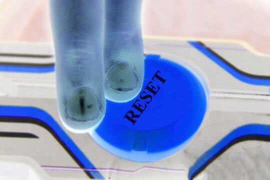 Blue glowing initiation start button with the text word RESET