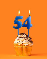 Blue candle number 54 - Birthday cupcake on orange background