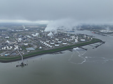 Chemical industry at terneuzen. DOW chemical park and petrochemical storage containers. Smokestacks and heay industry. Birds eye aerial drone view.